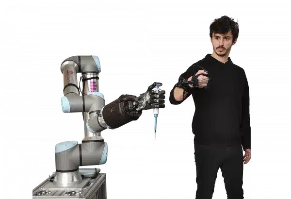 Image showing man controlling one robot arm with a Shadow Glove to use a syringe