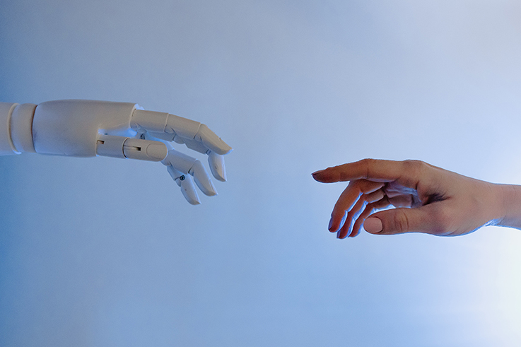 a robotic hand touches a human finger